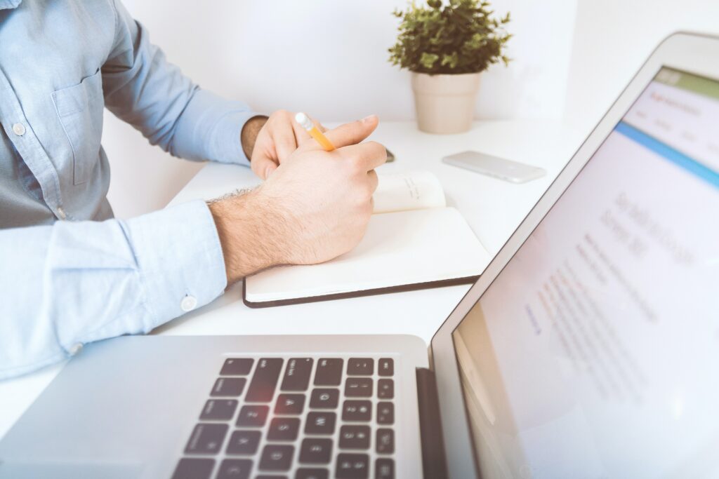 Businessman working and writing notes in office.